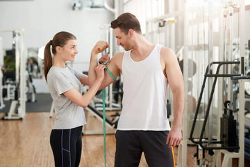 Sportliche Frau und sportlicher Mann trainieren gemeinsam im Fitnessstudio